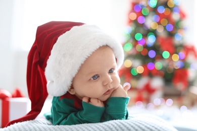 Photo of Cute baby in Christmas costume at home