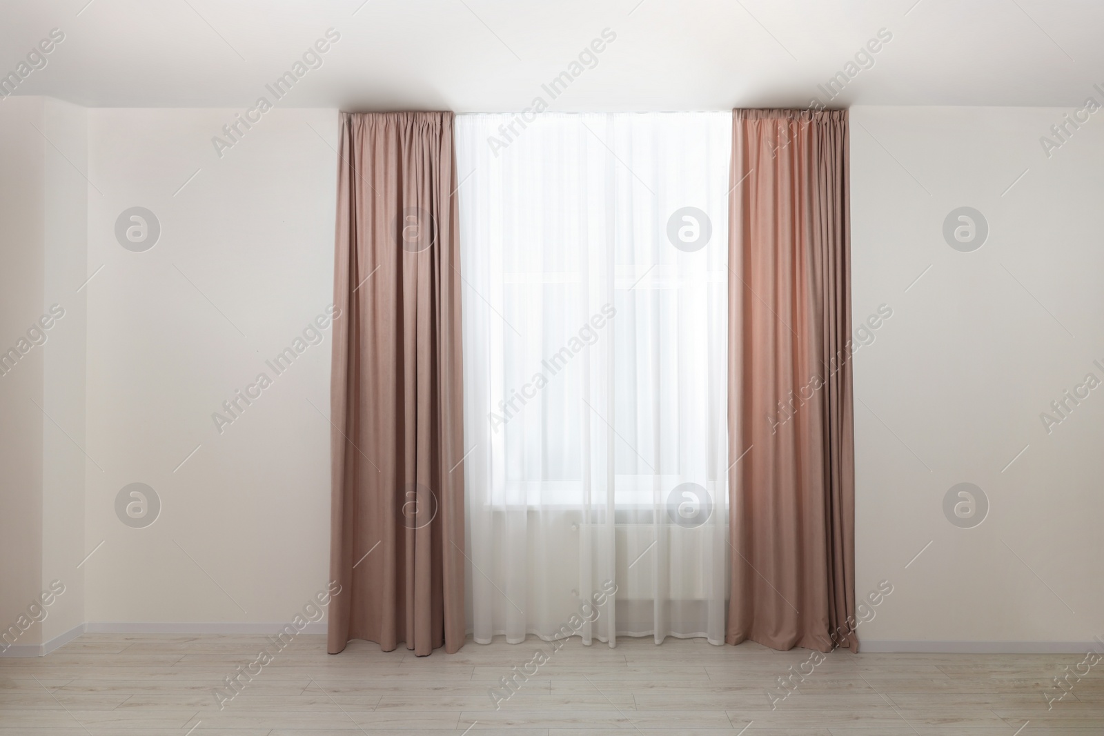 Photo of Elegant window curtains and white tulle indoors. Interior design