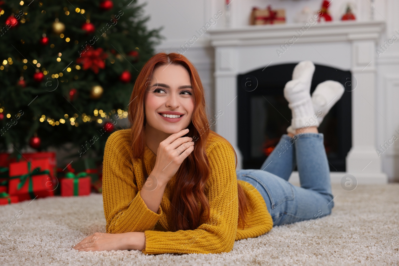 Photo of Beautiful young woman in room decorated for Christmas