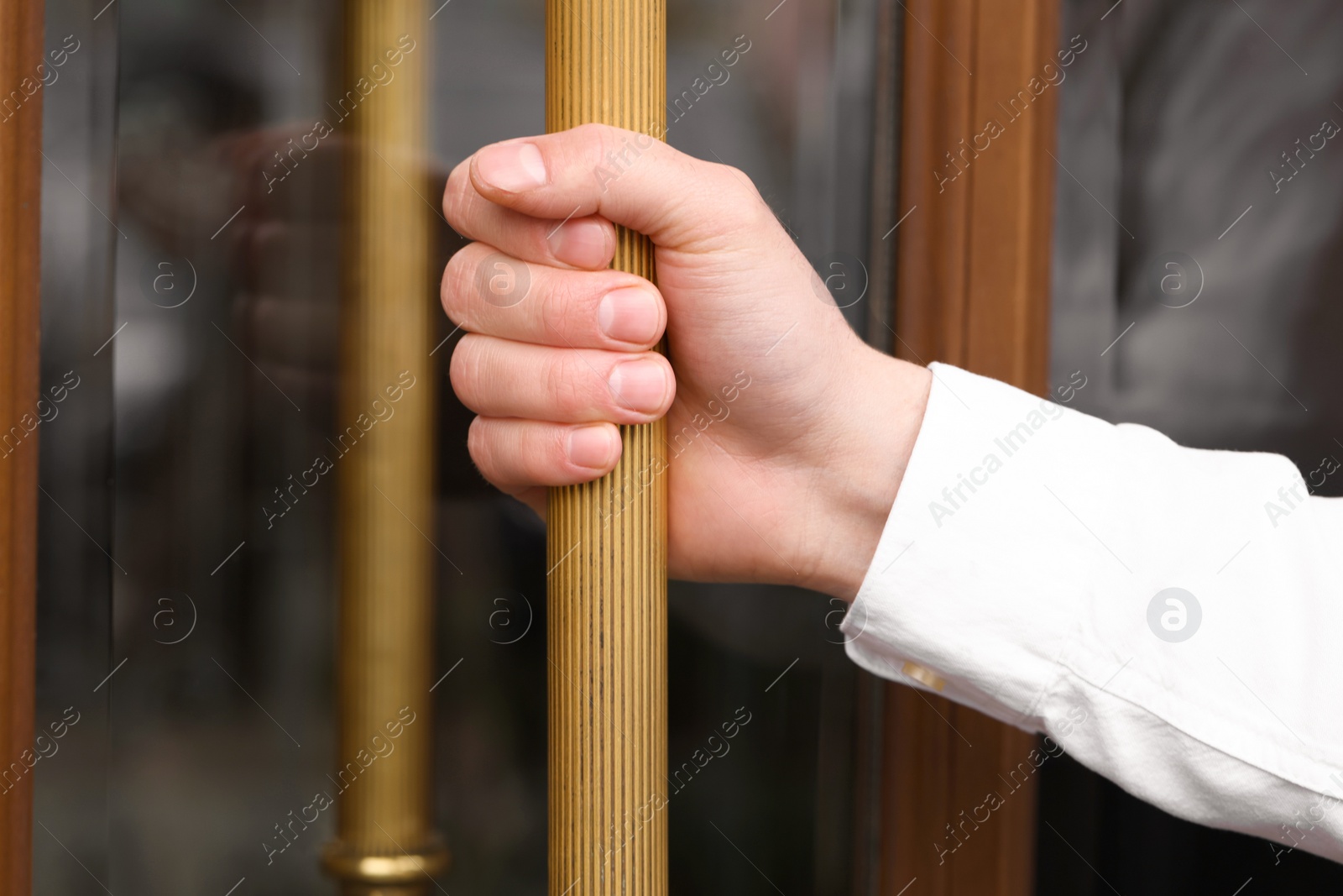 Photo of Butler opening hotel door, closeup of hand