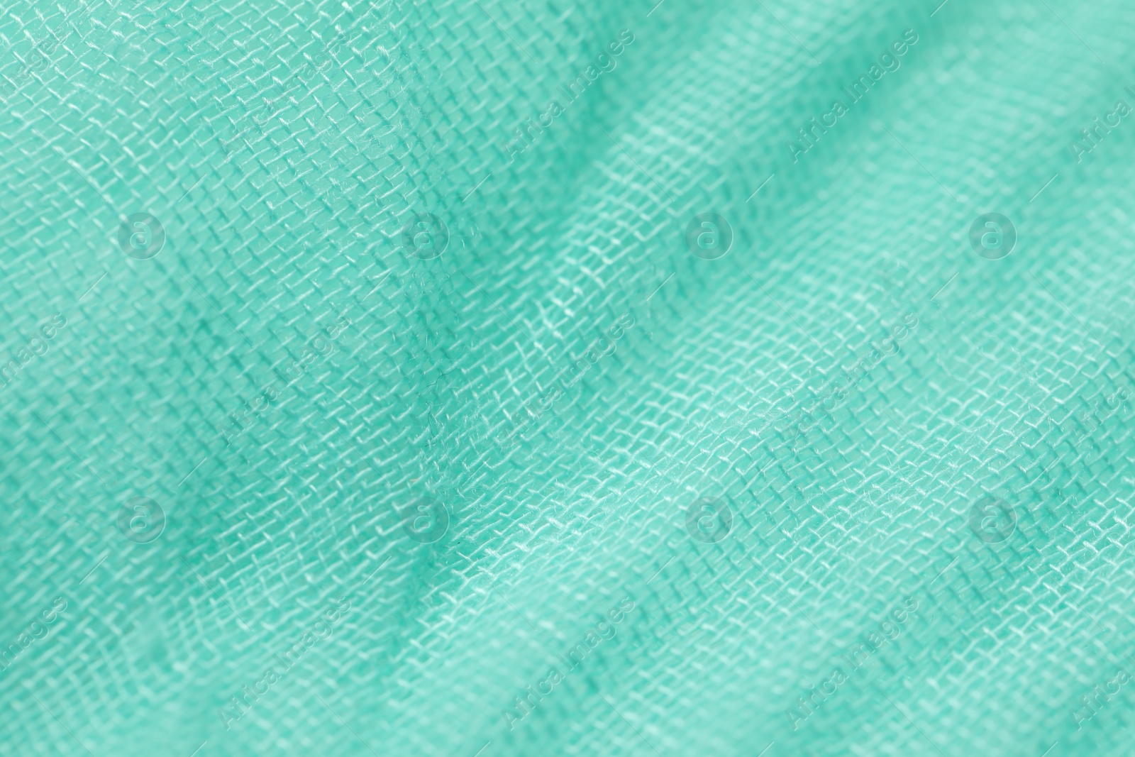 Photo of Texture of turquoise fabric as background, closeup