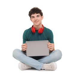 Photo of Portrait of student with laptop and headphones sitting on white background