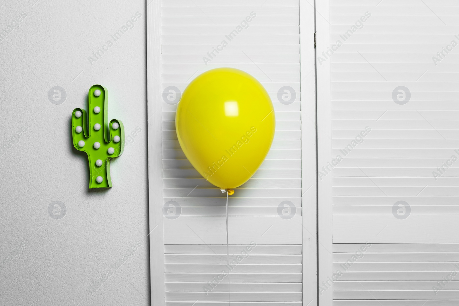 Photo of Yellow balloon on light background. Celebration time