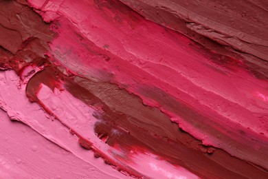 Texture of beautiful lipsticks as background, top view