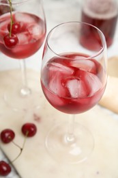Photo of Delicious cherry wine with ripe juicy berries on table