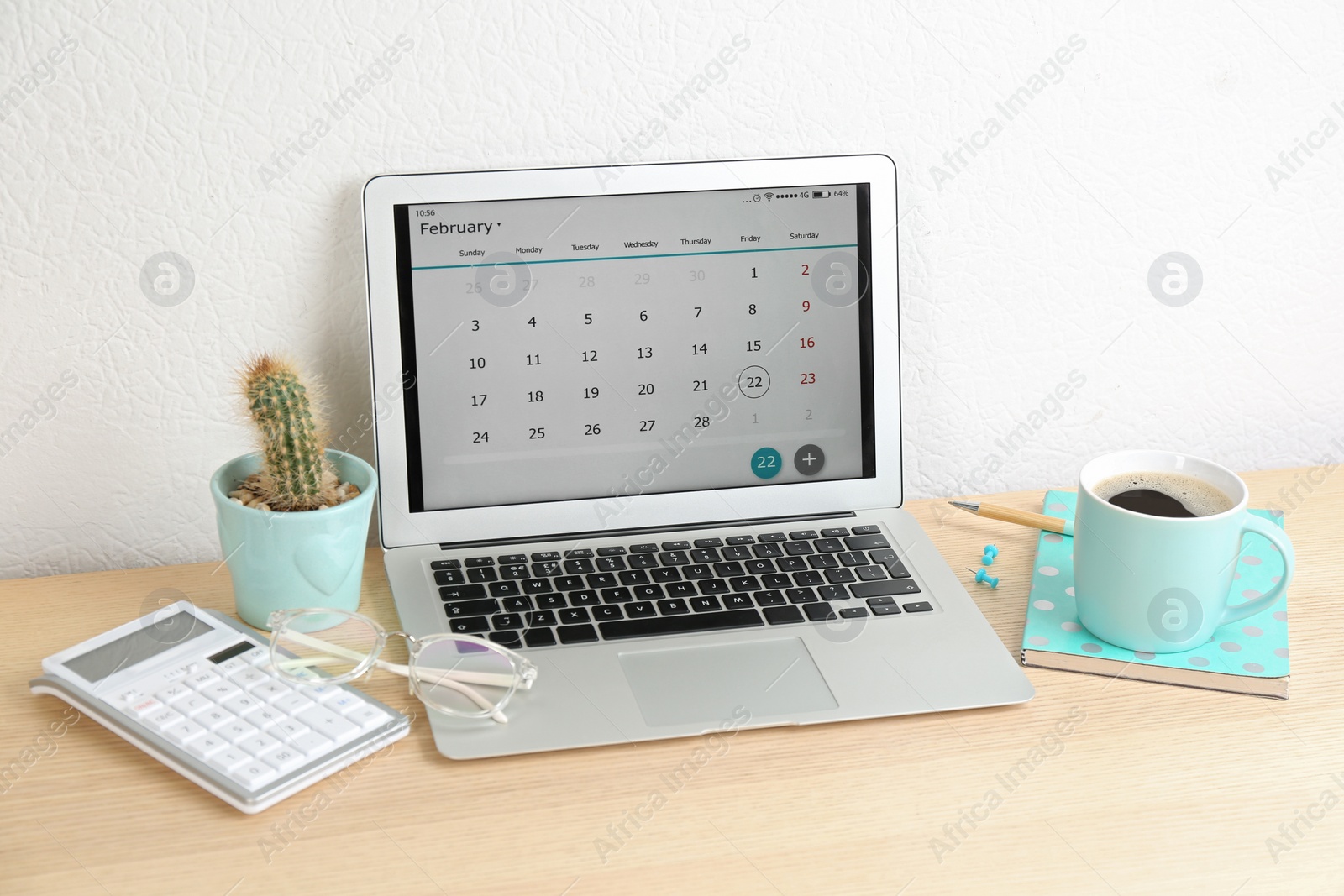 Photo of Modern laptop with calendar app in office