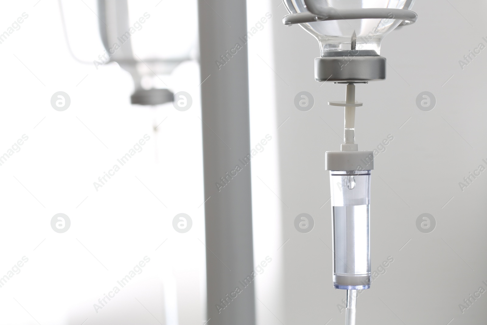 Photo of IV drip against blurred background, space for text