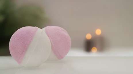 Photo of Bath bombs on tub indoors, closeup. Space for text