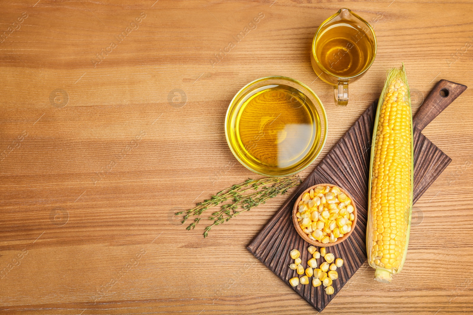 Photo of Flat lay composition with fresh corn oil on wooden table