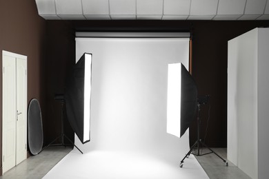 Photo of White photo background and professional lighting equipment in studio