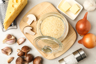 Flat lay composition with different ingredients on white table. Risotto recipe