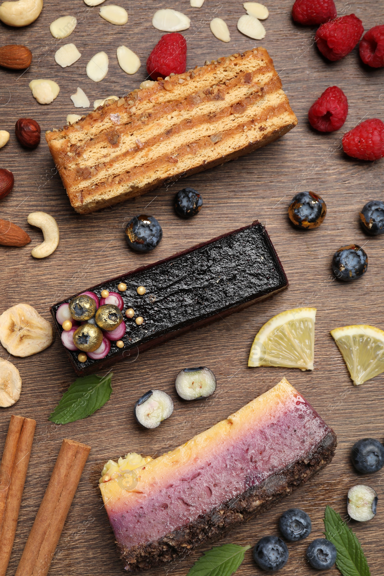 Photo of Flat lay composition with different tasty cakes on wooden table