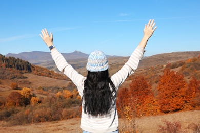 Photo of Female traveler feeling free in peaceful mountains