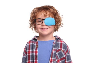 Photo of Smiling boy with eye patch on glasses against white background. Strabismus treatment