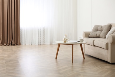 Photo of Parquet floor in room with sofa and coffee table