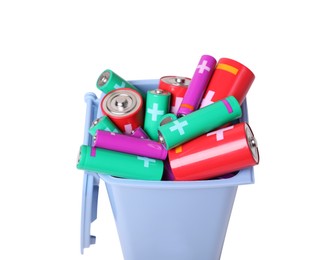 Photo of Many used batteries in recycling bin isolated on white