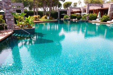 Photo of Outdoor swimming pool with umbrellas and sunbeds at resort