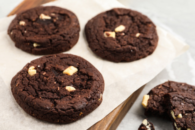 Photo of Delicious chocolate cookies on board, closeup view