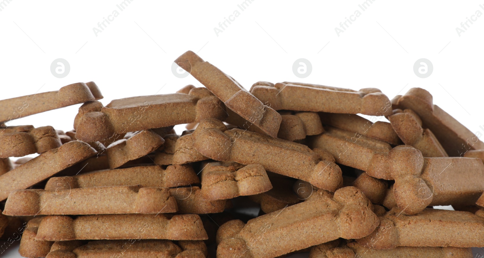 Photo of Pile of bone shaped dog cookies on white background, closeup