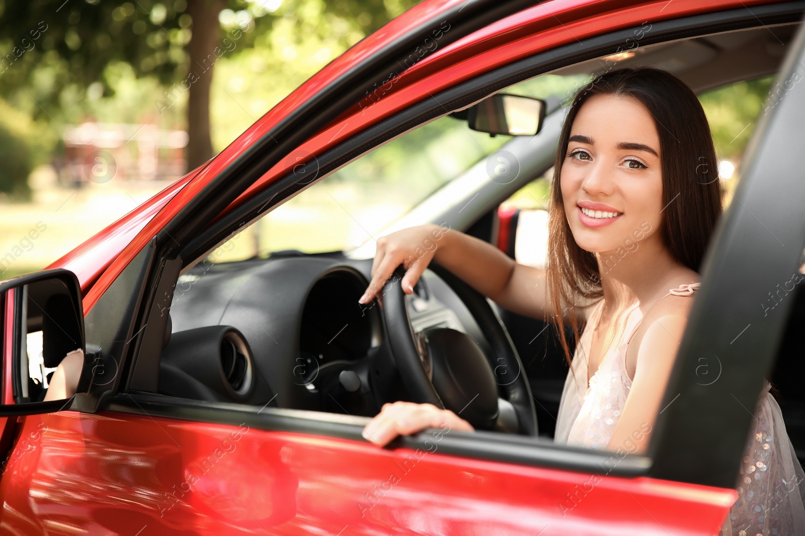 Photo of Young woman on driver's seat of car