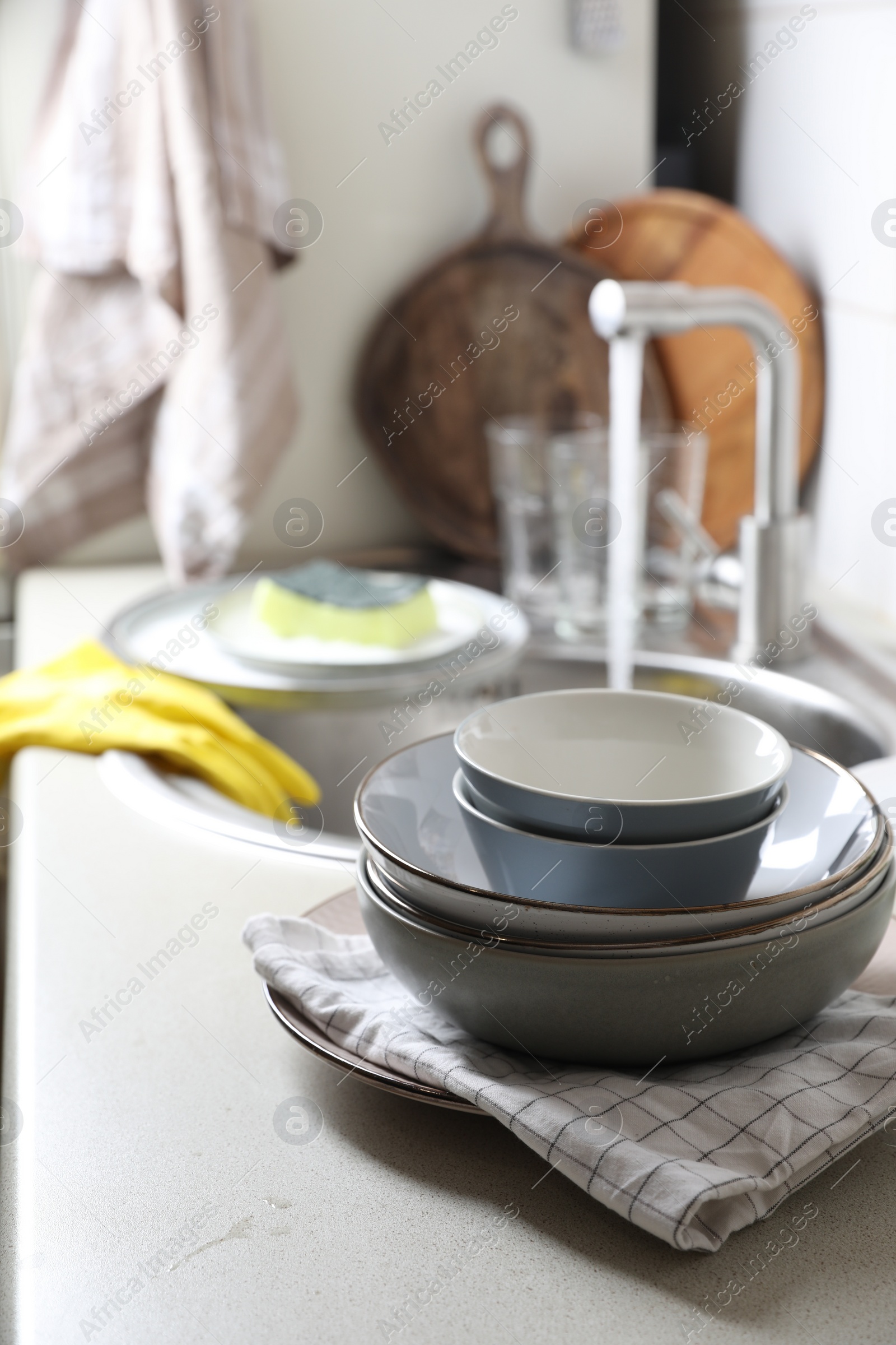 Photo of Clean bowls near kitchen sink. Washing dishes