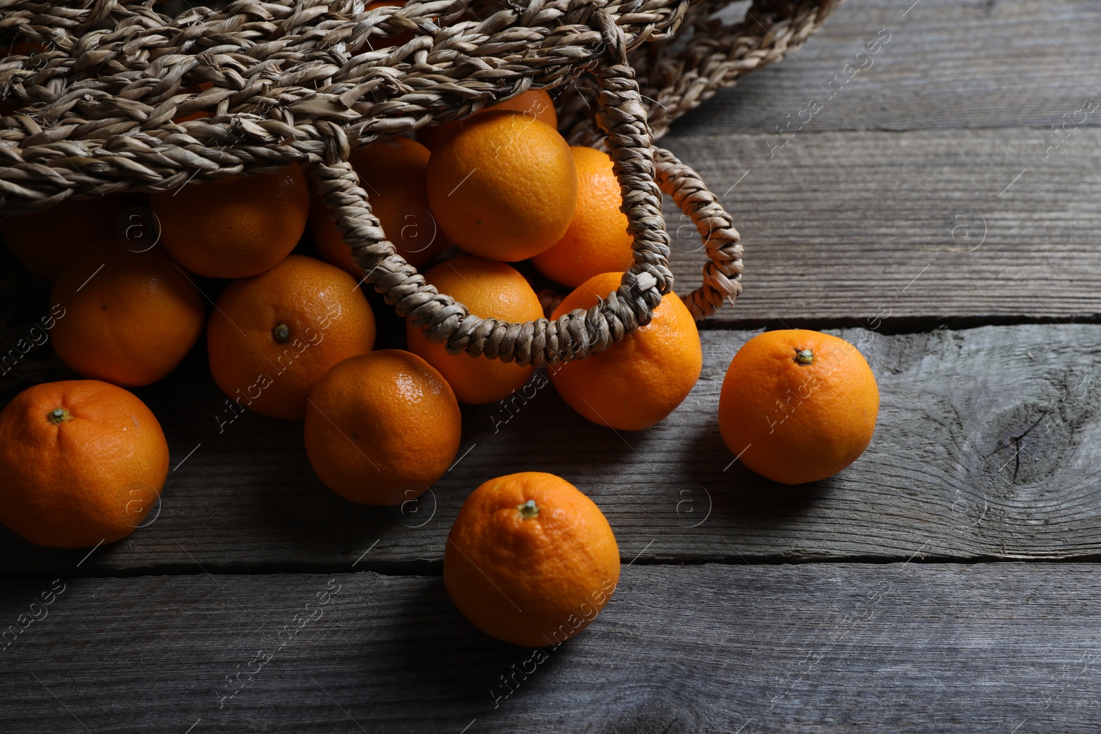 Photo of Many fresh ripe tangerines on wooden table, above view