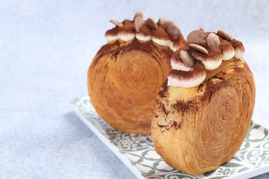 Tasty puff pastry. Supreme croissants with chocolate chips and cream on grey background, closeup. Space for text