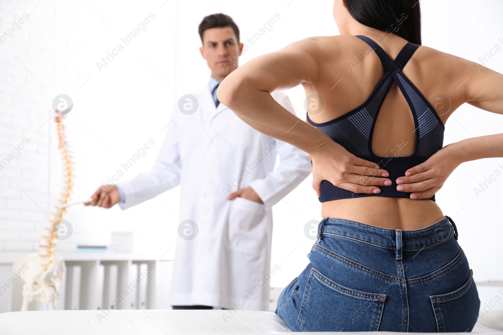 Photo of Young woman visiting orthopedist in medical office, closeup