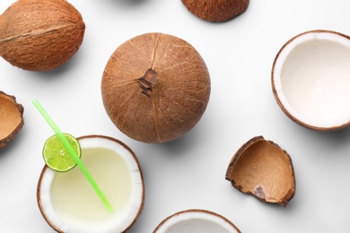 Photo of Composition with coconuts and drink on white background, top view