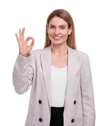 Photo of Beautiful happy businesswoman showing ok gesture on white background