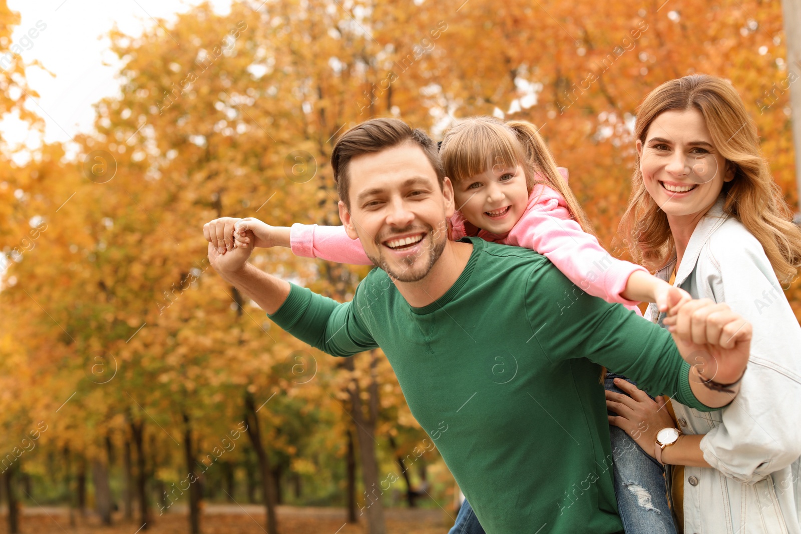 Photo of Happy family with child together in park. Autumn walk