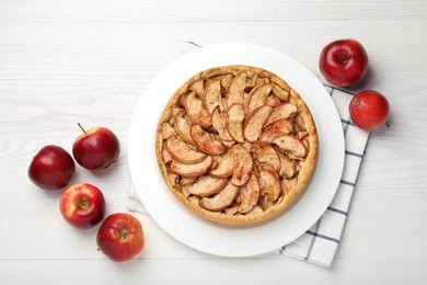 Photo of Delicious apple pie and fresh fruits on white wooden table, flat lay
