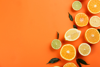 Photo of Flat lay composition with tangerines and different citrus fruits on orange background. Space for text