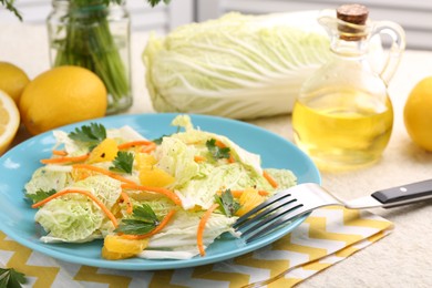 Tasty salad with Chinese cabbage, products and fork on table