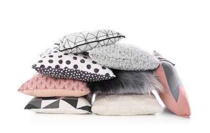 Photo of Pile of different colorful pillows on white background