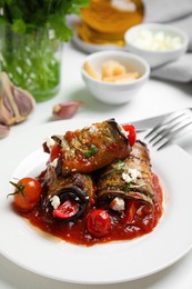 Tasty eggplant rolls served on white table, closeup