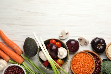 Photo of Different vegetables on white wooden table, flat lay and space for text. Vegan diet