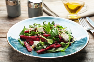 Plate with delicious beet salad served on table