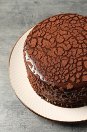 Photo of Delicious chocolate truffle cake on grey textured table