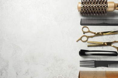 Professional hair dresser tools on grey textured background, flat lay. Space for text