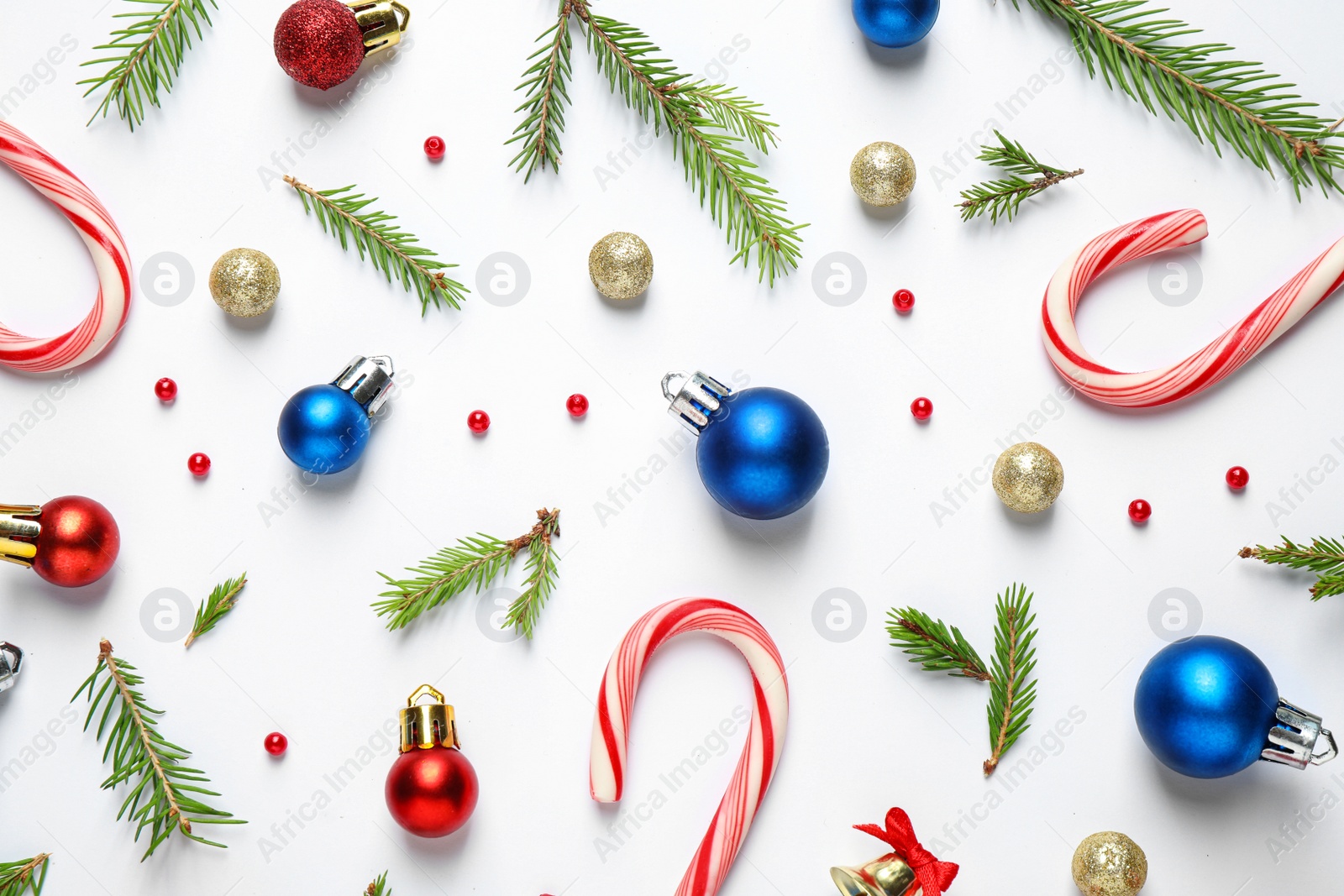 Photo of Flat lay composition with Christmas tree branches and festive decor on white background