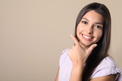 Photo of Young woman with healthy teeth on color background. Space for text