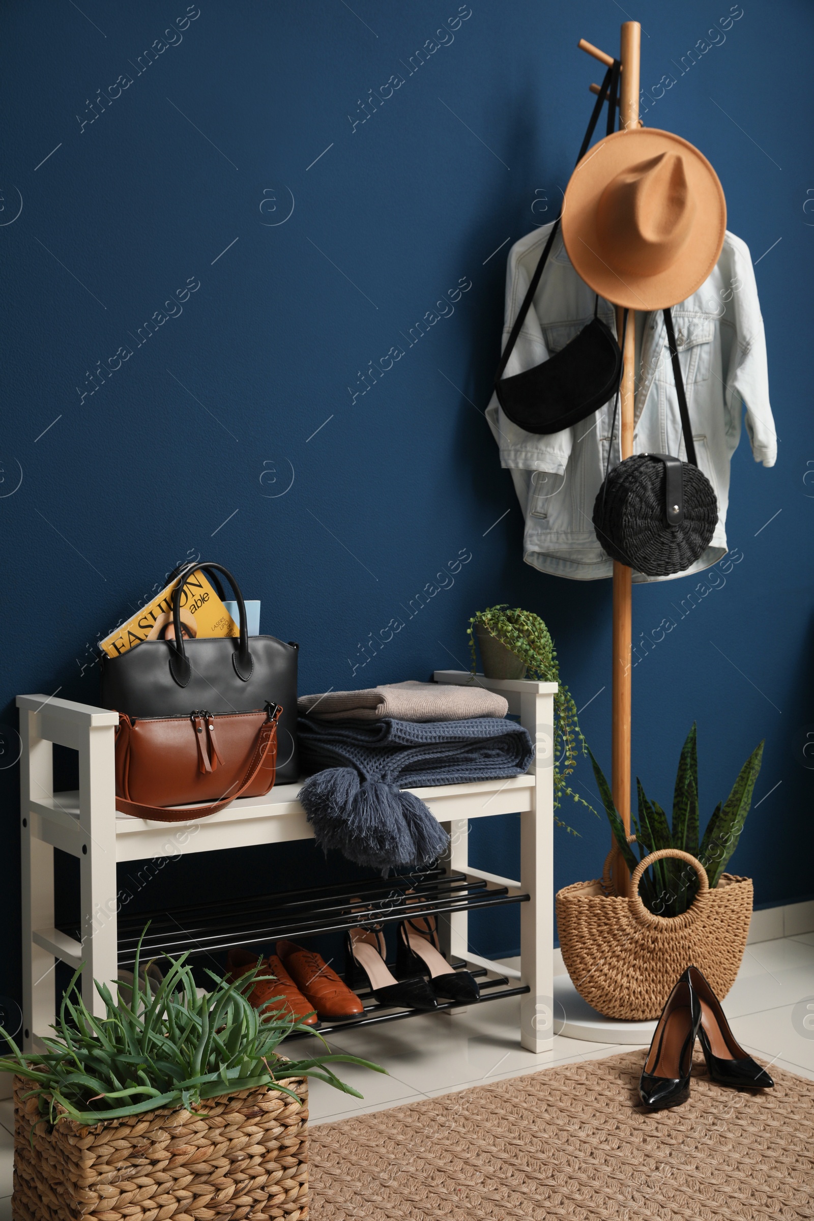 Photo of Hallway interior with stylish furniture, clothes and accessories