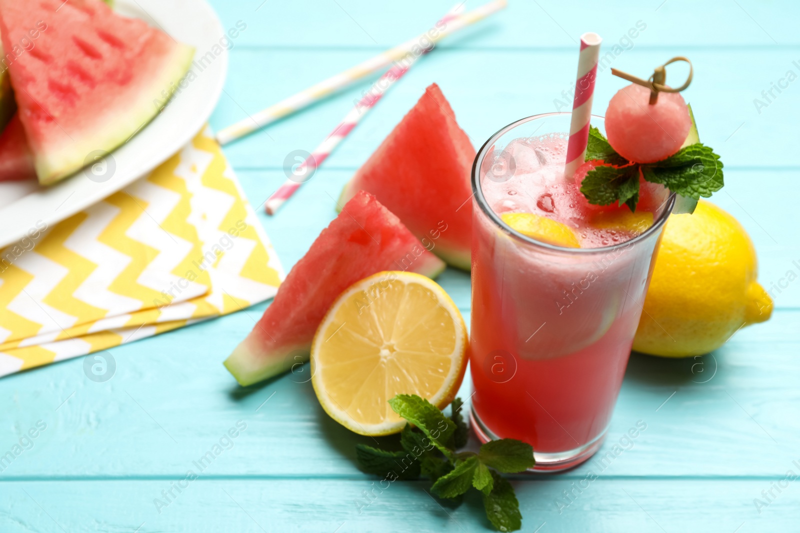 Photo of Delicious fresh watermelon drink on light blue wooden table