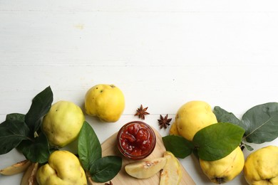 Photo of Delicious quince jam and fruits on white wooden table, flat lay. Space for text