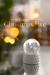 Image of Happy Christmas Eve, postcard design. Decorative  snow globe on mirror surface