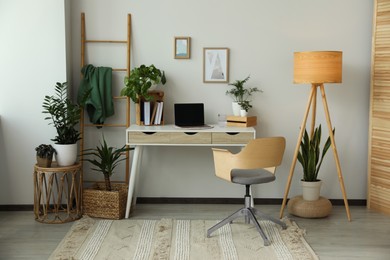 Photo of Home office interior with different beautiful houseplants