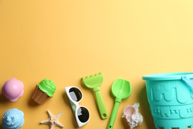 Photo of Flat lay composition with bright beach toys on color background. Space for text