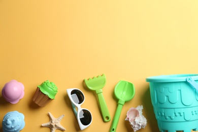 Flat lay composition with bright beach toys on color background. Space for text