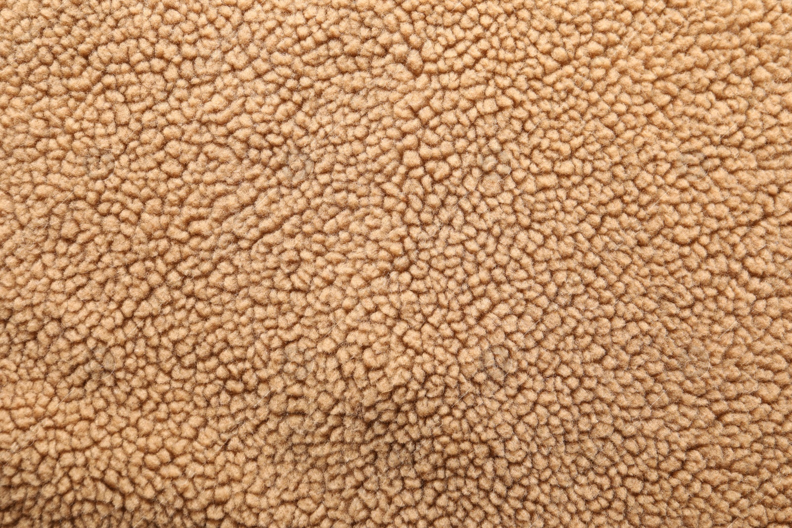 Photo of Texture of light brown faux fur as background, top view